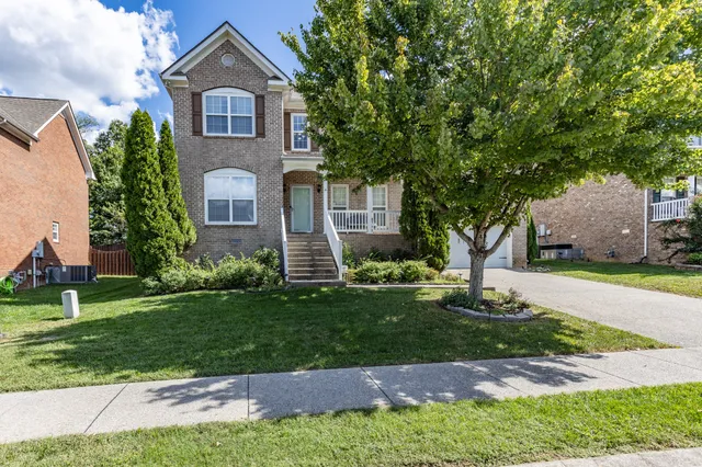 a front view of a house with a yard