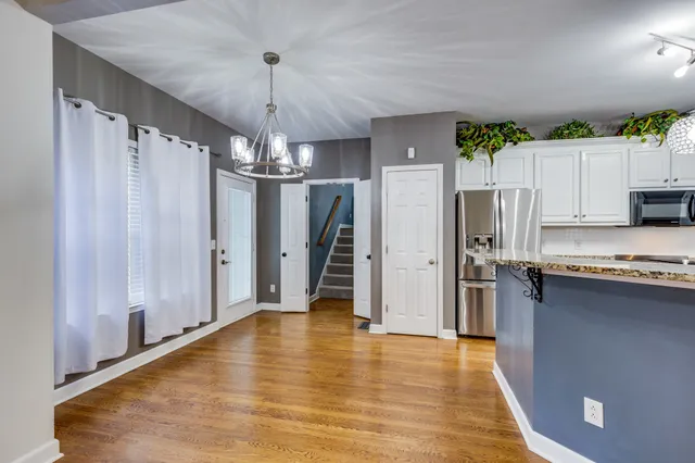 a kitchen with stainless steel appliances granite countertop a refrigerator a sink and a stove