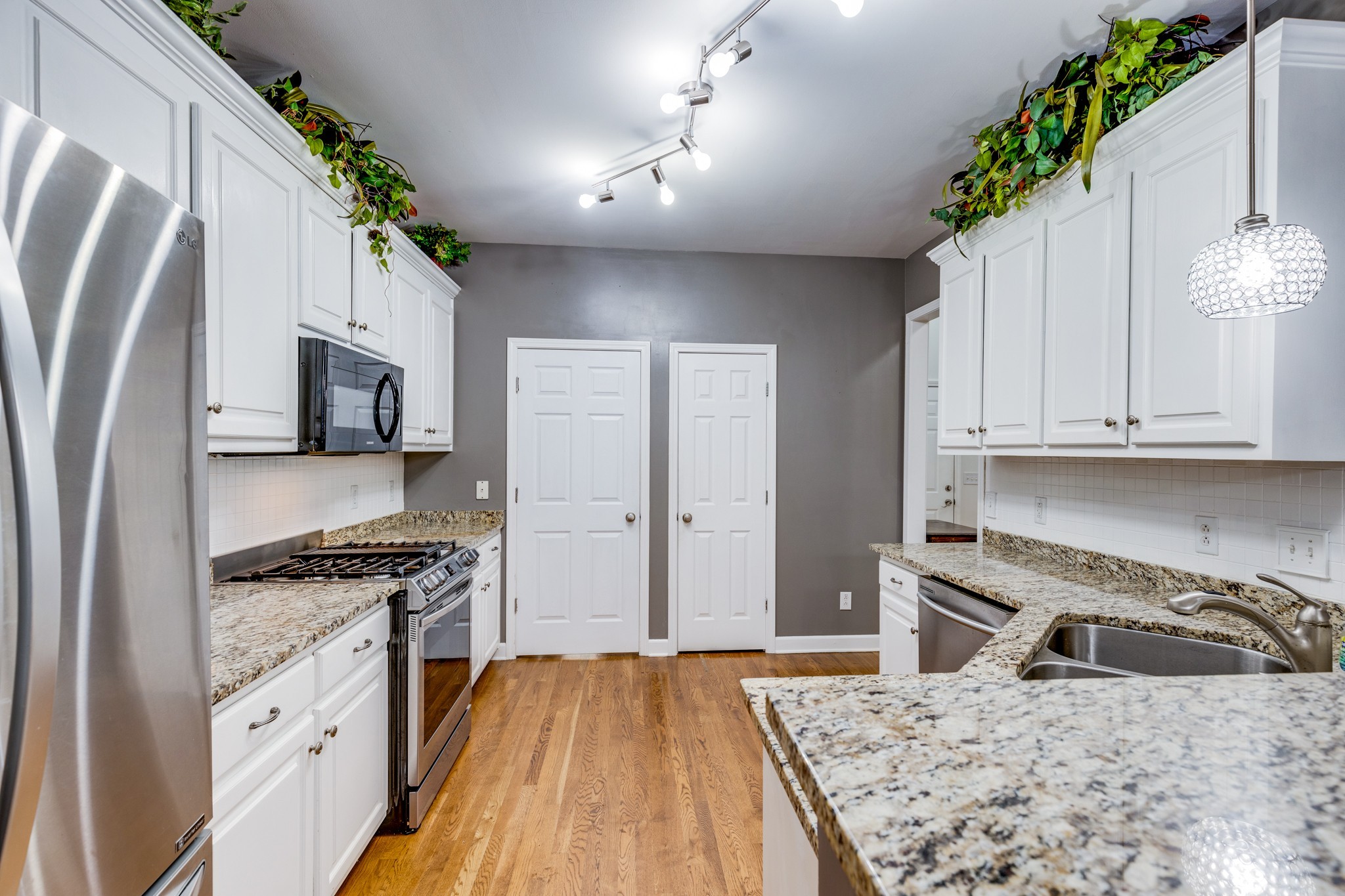 1024 Belcor Drive Spring Hill, TN 37174 - Photo 19 of 41 a kitchen with granite countertop a sink stove and refrigerator