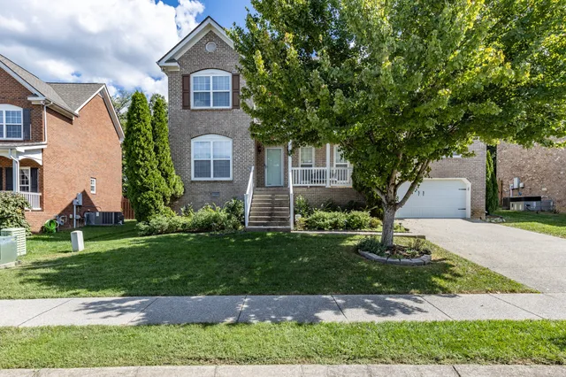 a front view of a house with a garden