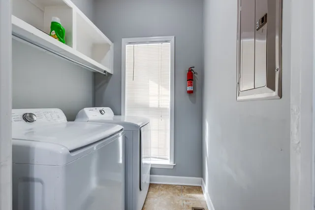 a view of a room with wooden floor and a ceiling fan