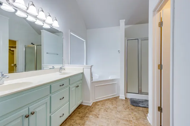a bathroom with a tub sink and a mirror