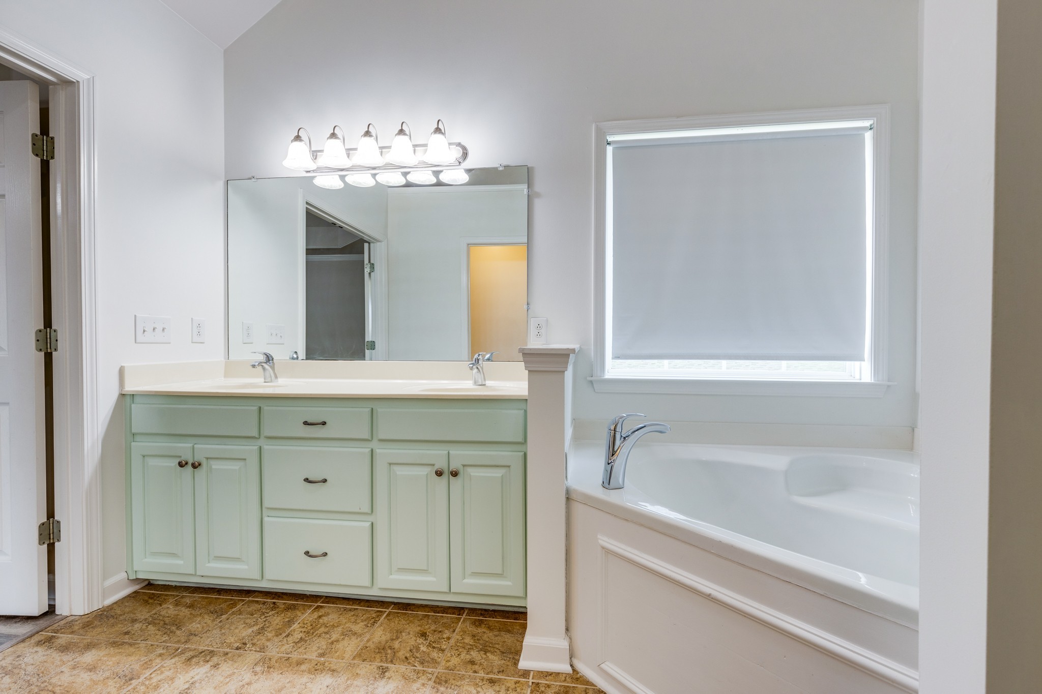 1024 Belcor Drive Spring Hill, TN 37174 - Photo 26 of 41 a bathroom with a tub sink and a mirror