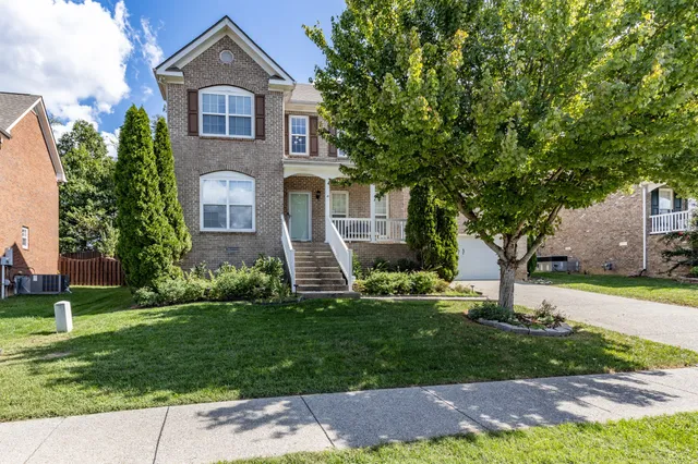 a front view of a house with a yard