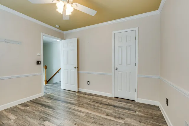 a bathroom with a toilet sink vanity and mirror