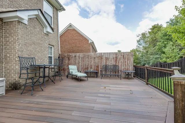 a swimming pool with outdoor seating and garden