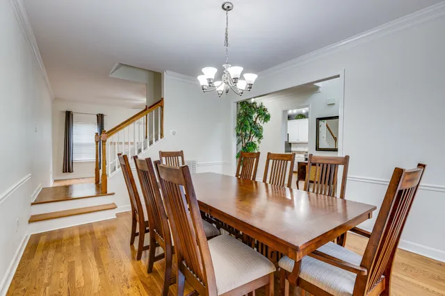 a view of an empty room with wooden floor fireplace and a window