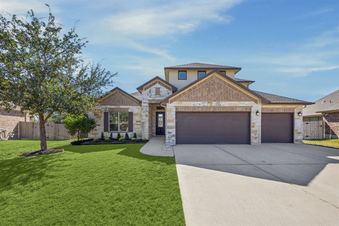3329 Eagle Ridge Lane Pflugerville, TX 78660 - Photo 1 of 35 View of front of home featuring driveway, an attached garage, and stone siding
