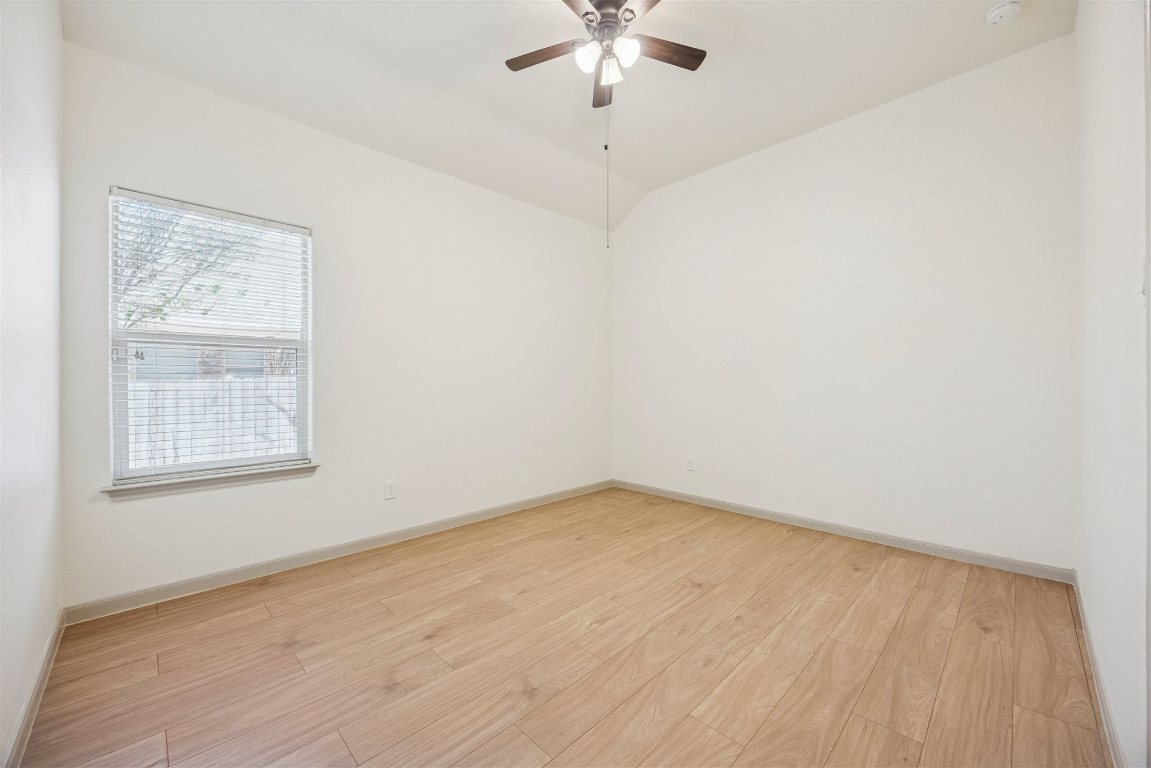 3329 Eagle Ridge Lane Pflugerville, TX 78660 - Photo 20 of 35 Empty room with light wood-style floors, lofted ceiling, and a ceiling fan