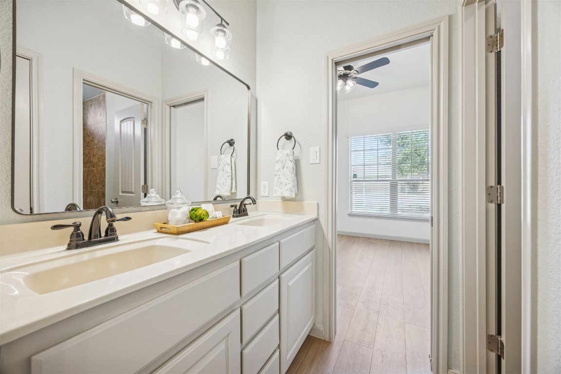 3329 Eagle Ridge Lane Pflugerville, TX 78660 - Photo 24 of 35 Bathroom featuring double vanity, light wood-style flooring, and a ceiling fan