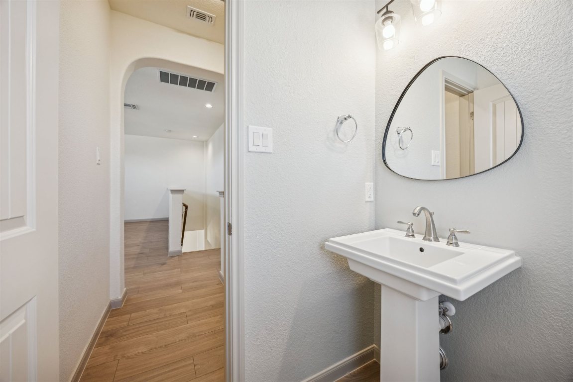 3329 Eagle Ridge Lane Pflugerville, TX 78660 - Photo 25 of 35 Bathroom with a textured wall and light wood-style flooring