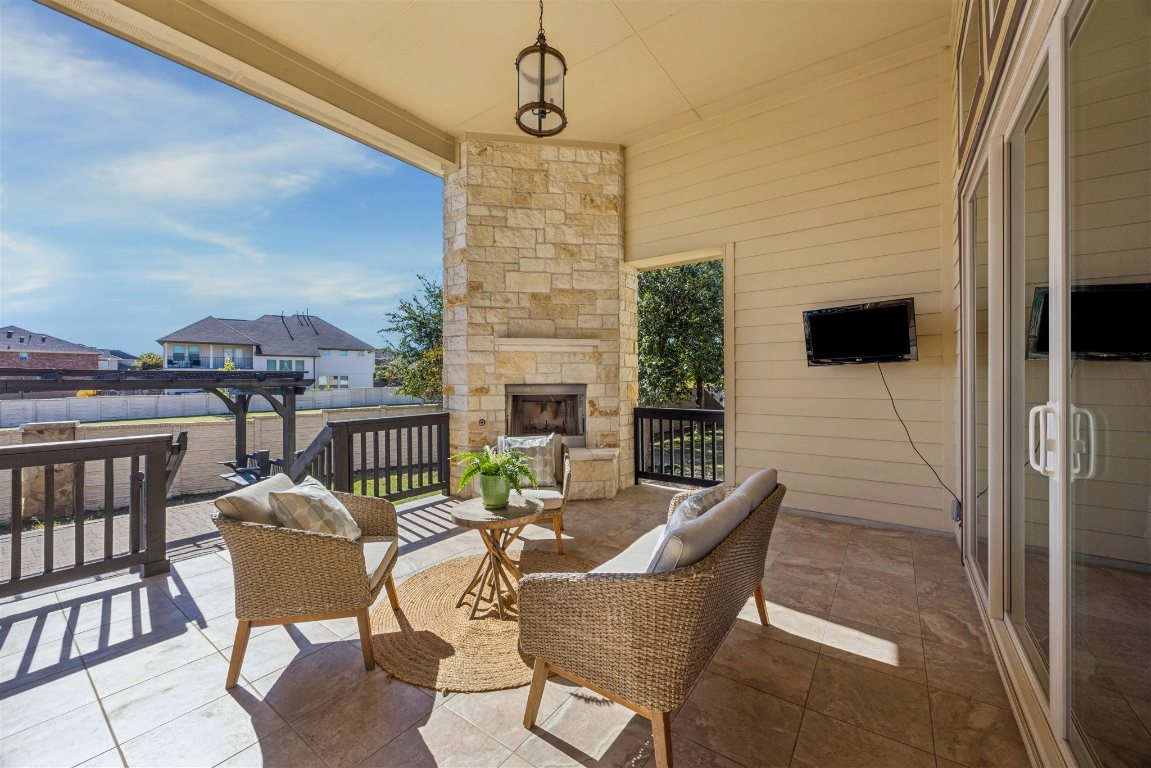 3329 Eagle Ridge Lane Pflugerville, TX 78660 - Photo 26 of 35 View of patio featuring an outdoor stone fireplace