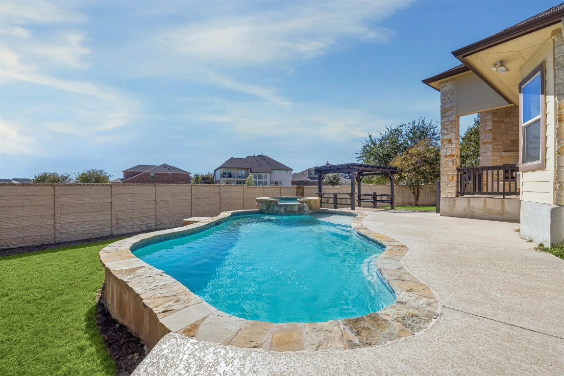 3329 Eagle Ridge Lane Pflugerville, TX 78660 - Photo 29 of 35 View of pool with a patio, a fenced backyard, a pool with connected hot tub, and a pergola