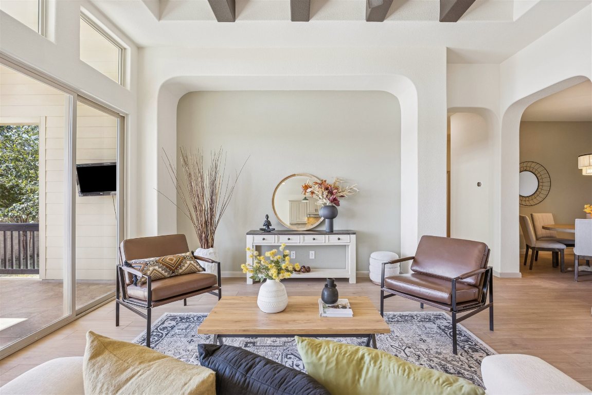 3329 Eagle Ridge Lane Pflugerville, TX 78660 - Photo 8 of 35 Living area with arched walkways and wood finished floors