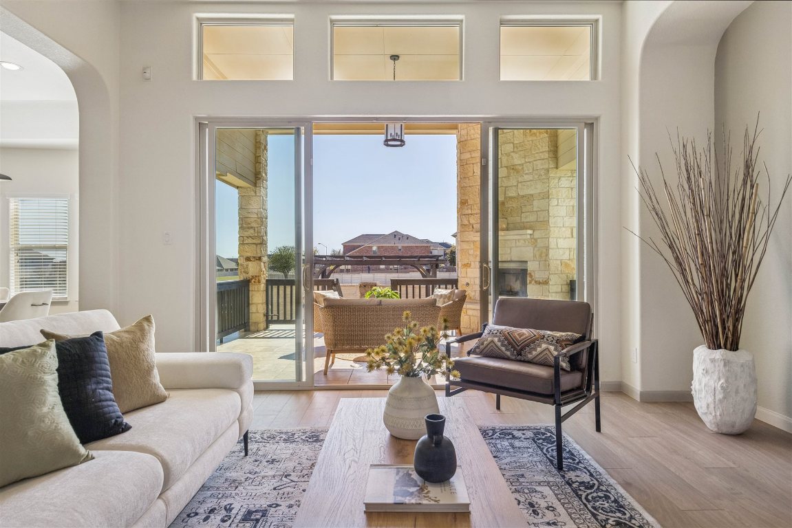 3329 Eagle Ridge Lane Pflugerville, TX 78660 - Photo 10 of 35 Living area with arched walkways and wood finished floors