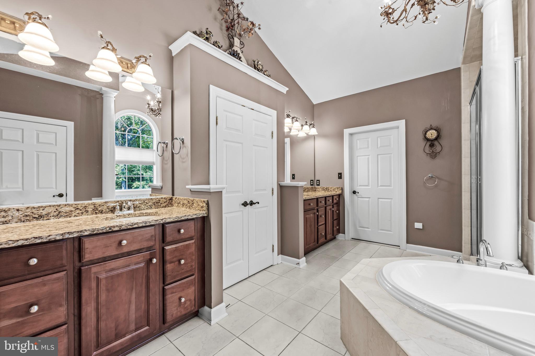 1703 Lake Forest Drive Finksburg, MD 21048 - Photo 40 of 82 a spacious bathroom with a granite countertop sink mirror and shower