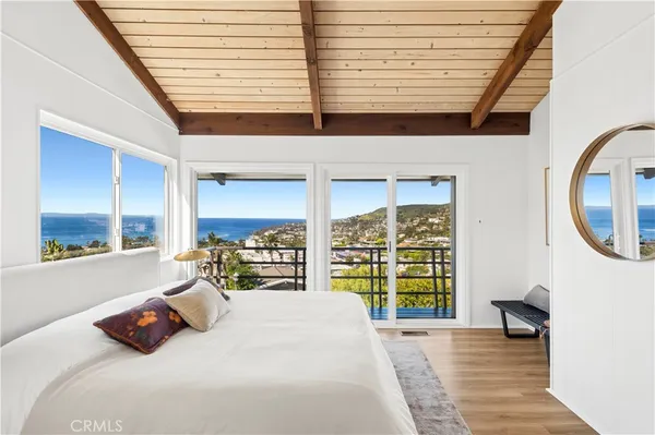 a bedroom with a bed and a large window with outer view