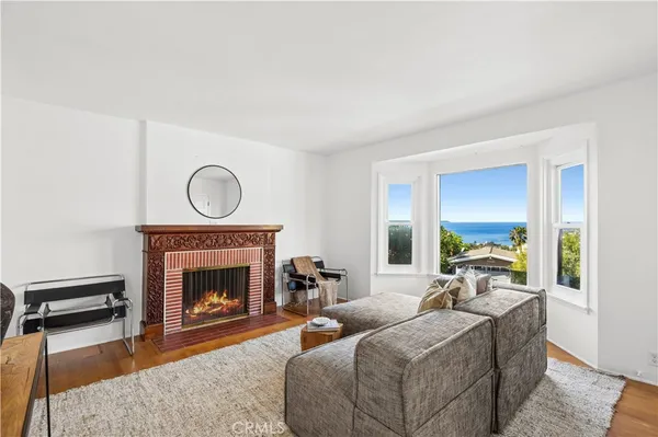 a living room with furniture a window and a fireplace