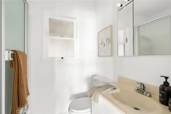 a bathroom with a sink toilet and vanity