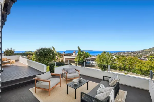 a view of a terrace with couches and sky view