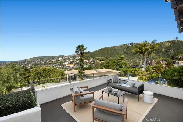 a view of a terrace with couches and sky view