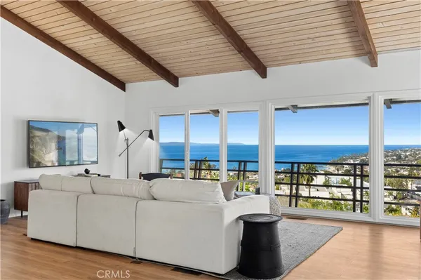 a living room with furniture and large windows