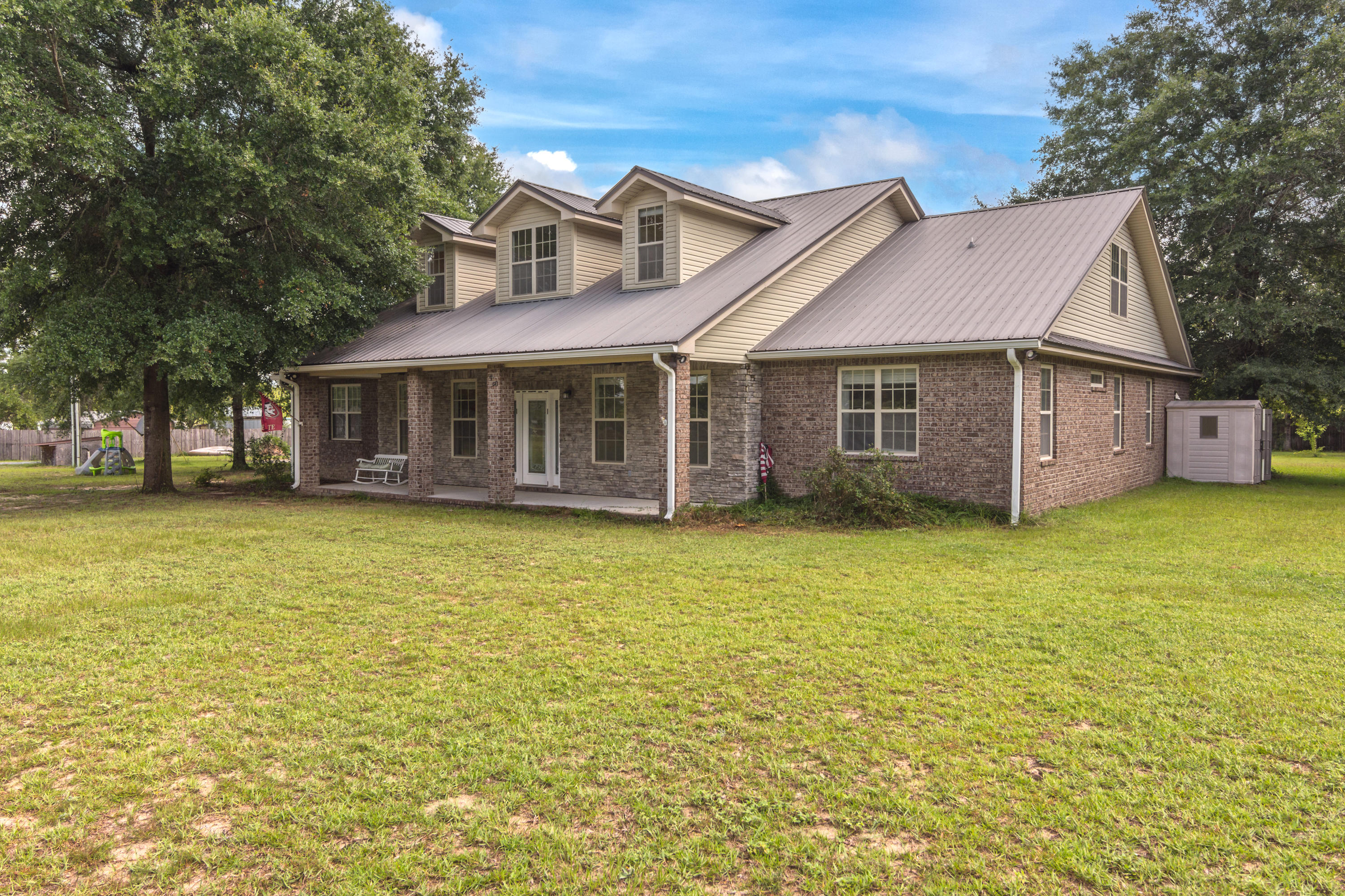 960 Long Road DeFuniak Springs, FL 32433 - Photo 1 of 38 a view of a house with a garden and tree