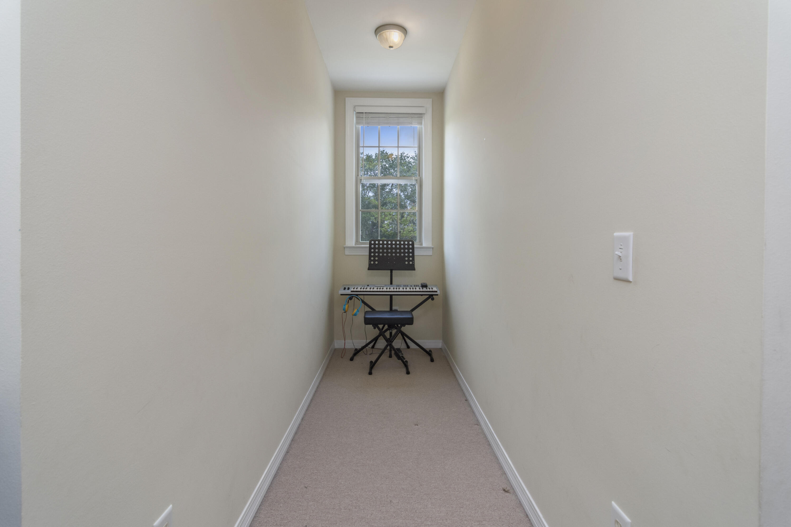 960 Long Road DeFuniak Springs, FL 32433 - Photo 32 of 38 a view of a livingroom with a chair and a potted plant