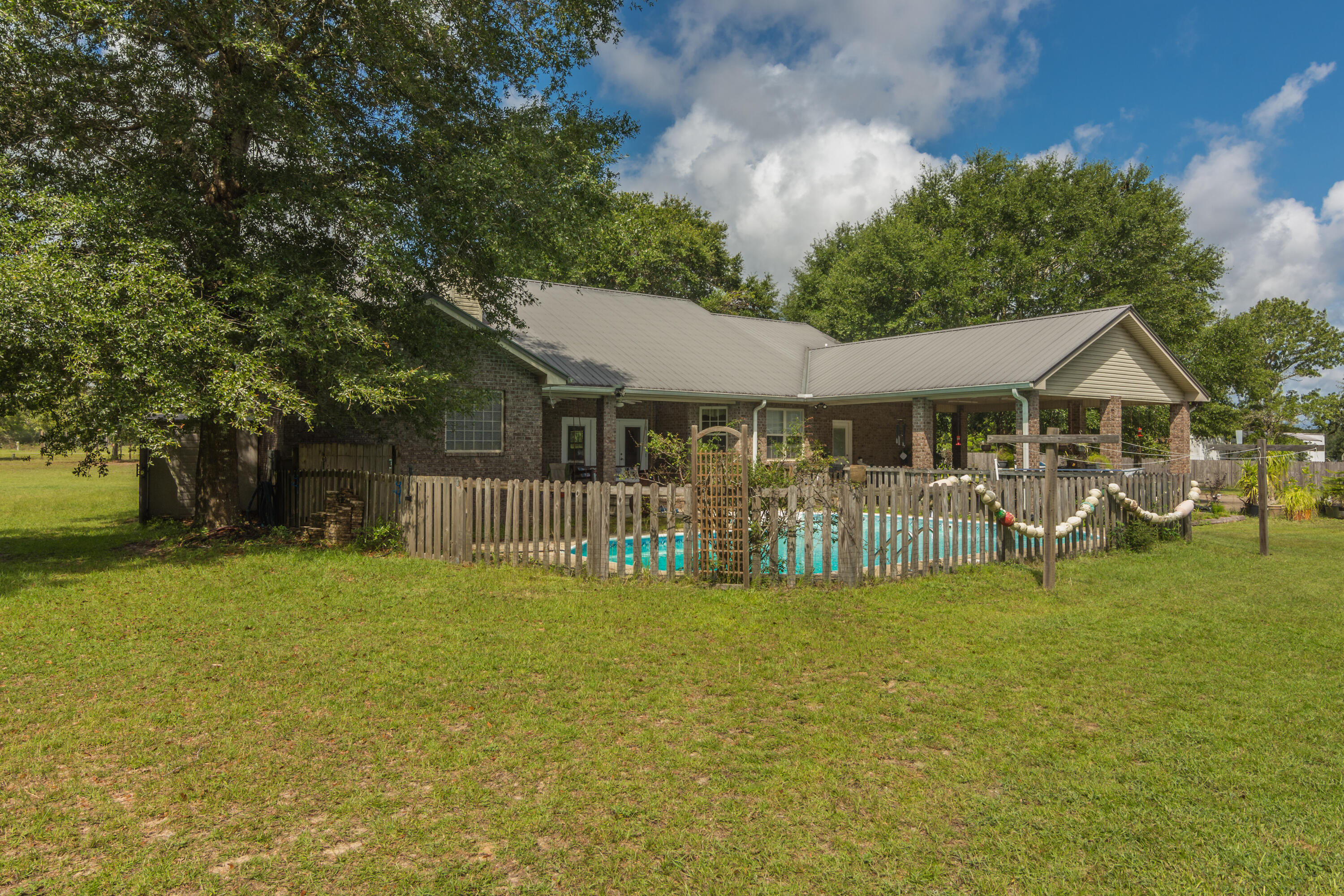 960 Long Road DeFuniak Springs, FL 32433 - Photo 36 of 38 a view of a house with swimming pool and sitting area