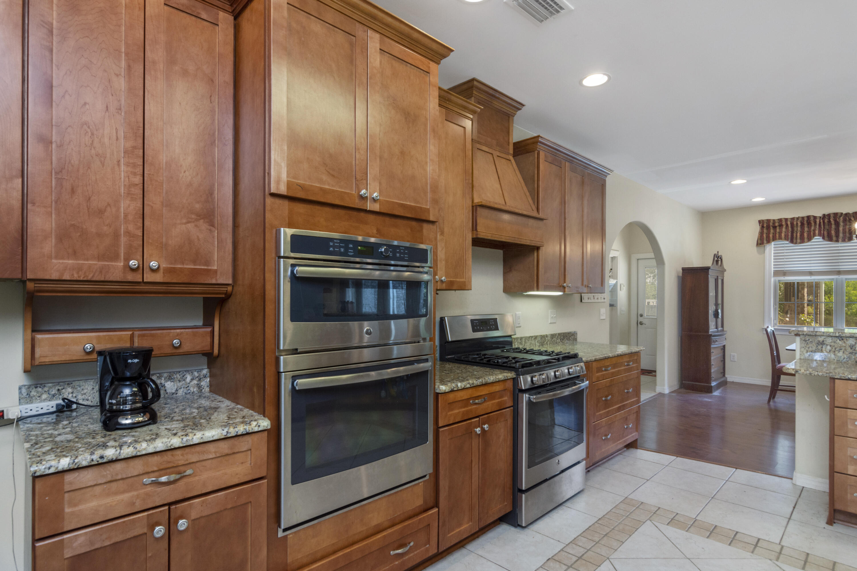 960 Long Road DeFuniak Springs, FL 32433 - Photo 5 of 38 a kitchen with stainless steel appliances granite countertop a stove a sink and a refrigerator