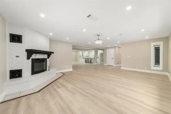 a view of a kitchen with a sink and a fireplace