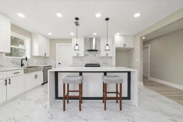 a kitchen with a sink cabinets and wooden floor