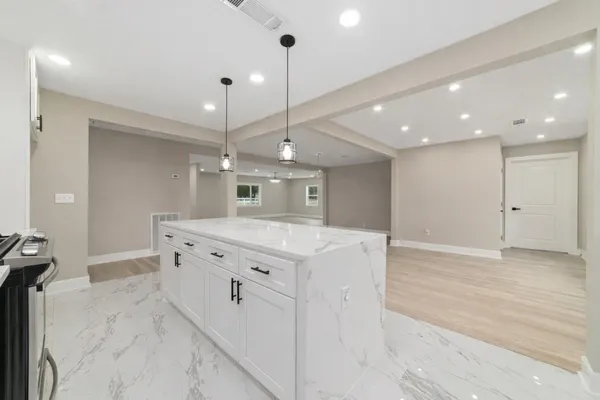 a spacious bathroom with a granite countertop sink a mirror and a shower