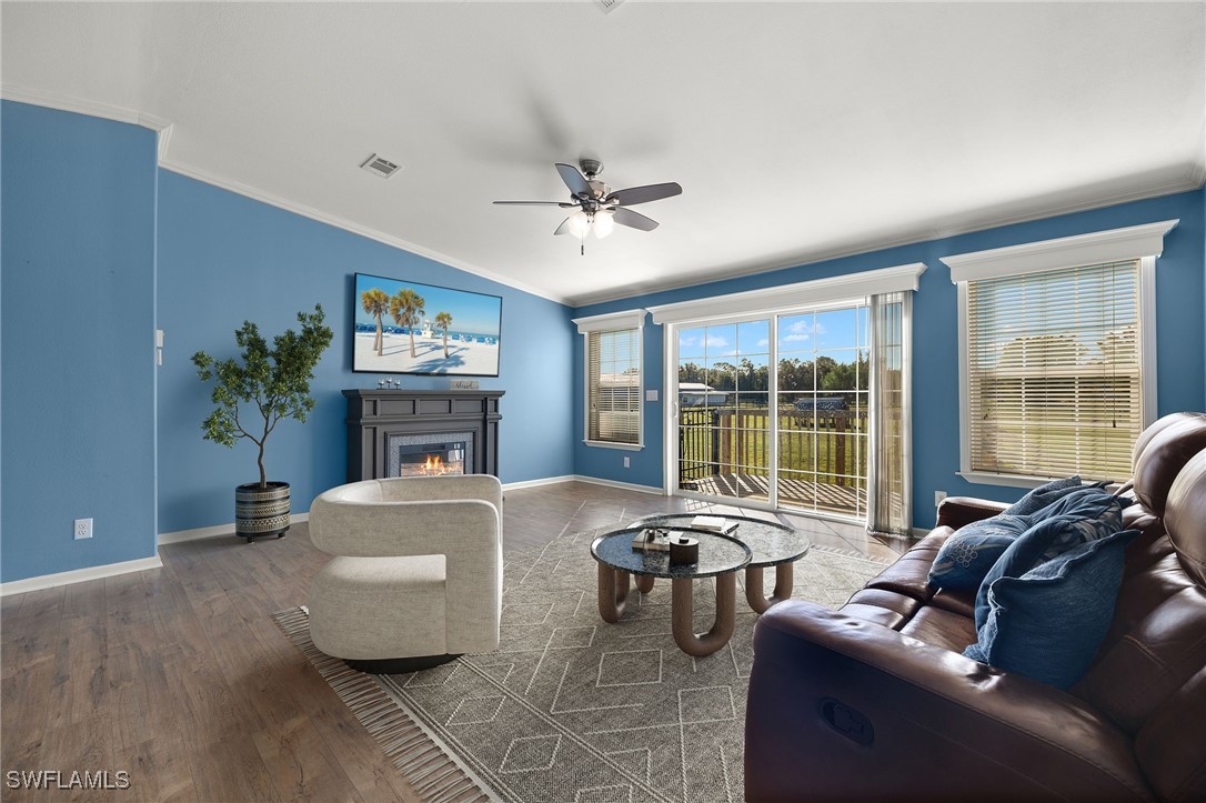 11720 Ruden Road North Fort Myers, FL 33917 - Photo 3 of 48 a living room with furniture a fireplace and a large window