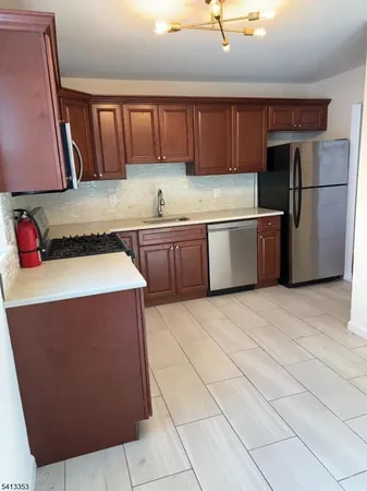 a kitchen with stainless steel appliances granite countertop a refrigerator sink and cabinets
