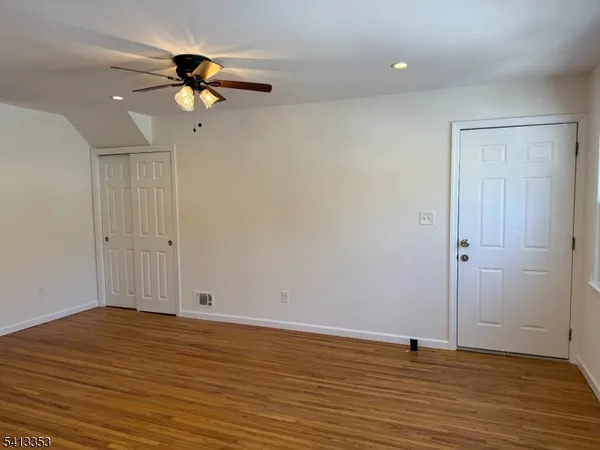 a view of a room with wooden floor and window