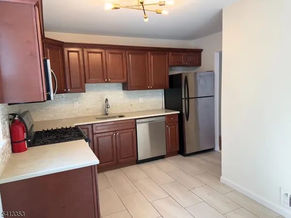 a kitchen with a refrigerator sink and cabinets