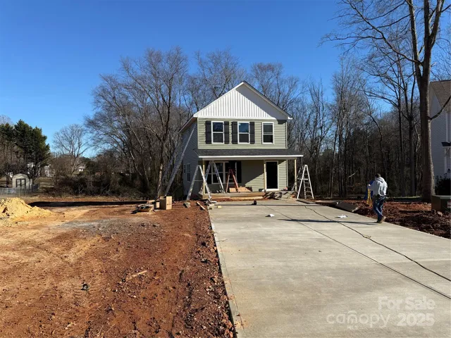 a view of house with yard in front of house