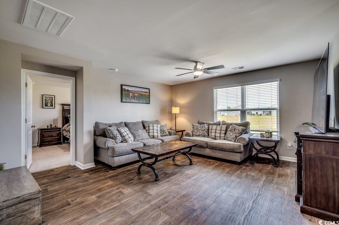 777 Woodland Farms Circle Aynor, SC 29511 - Photo 11 of 31 Living room featuring visible vents, ceiling fan, and wood finished floors