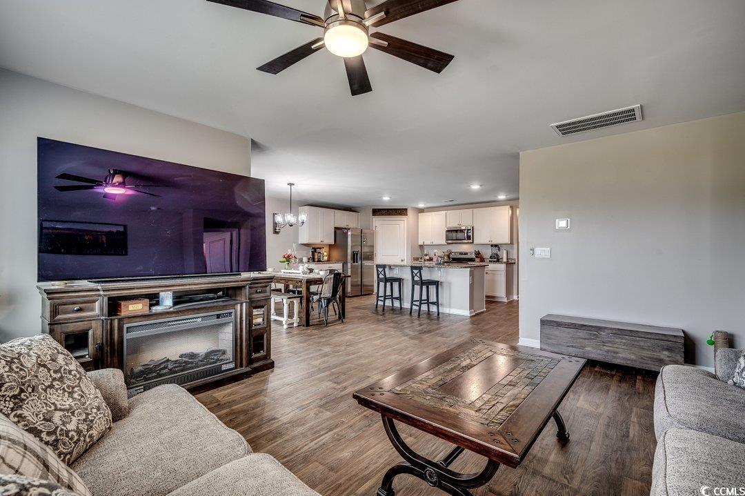 777 Woodland Farms Circle Aynor, SC 29511 - Photo 13 of 31 Living area featuring visible vents, baseboards, recessed lighting, dark wood-type flooring, and ceiling fan with notable chandelier