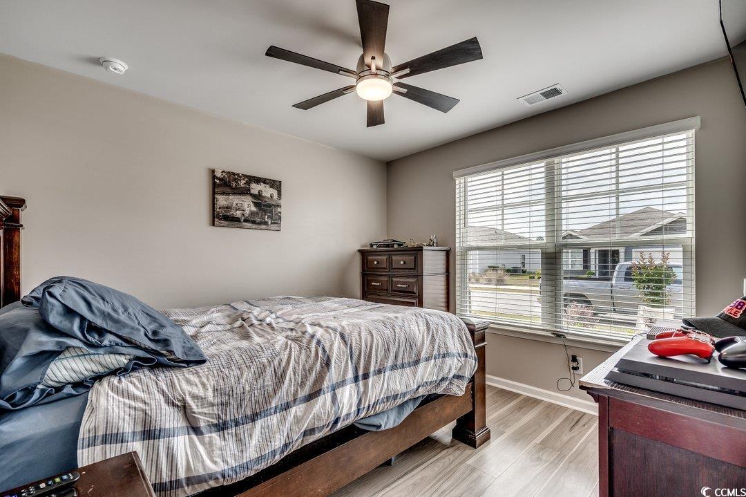 777 Woodland Farms Circle Aynor, SC 29511 - Photo 22 of 31 Bedroom with light wood-type flooring, a ceiling fan, visible vents, and baseboards