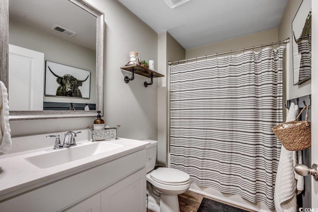 777 Woodland Farms Circle Aynor, SC 29511 - Photo 24 of 31 Bathroom with wood finished floors, a shower with curtain, toilet, vanity, and visible vents