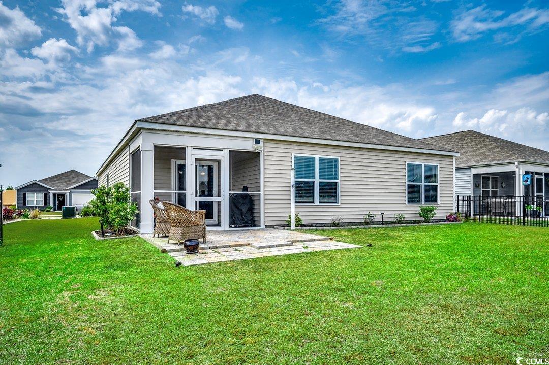 777 Woodland Farms Circle Aynor, SC 29511 - Photo 29 of 31 Rear view of house featuring fence, a yard, a patio, and a sunroom