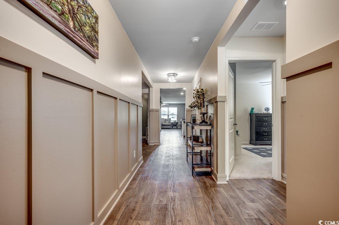 777 Woodland Farms Circle Aynor, SC 29511 - Photo 4 of 31 Hallway featuring wood finished floors, visible vents, and baseboards