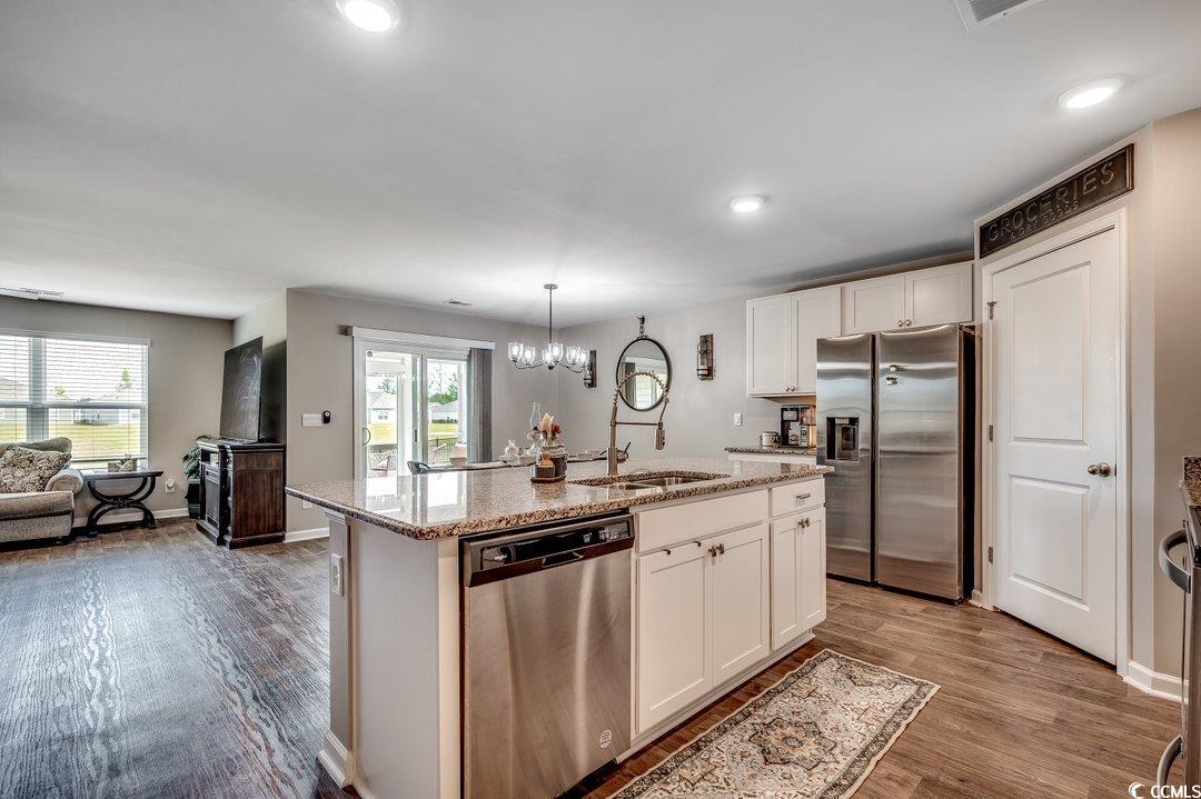 777 Woodland Farms Circle Aynor, SC 29511 - Photo 5 of 31 Kitchen with wood finished floors, stainless steel appliances, white cabinetry, and a sink