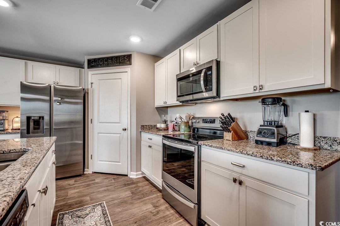 777 Woodland Farms Circle Aynor, SC 29511 - Photo 6 of 31 Kitchen featuring stainless steel appliances, recessed lighting, light wood finished floors, and white cabinets