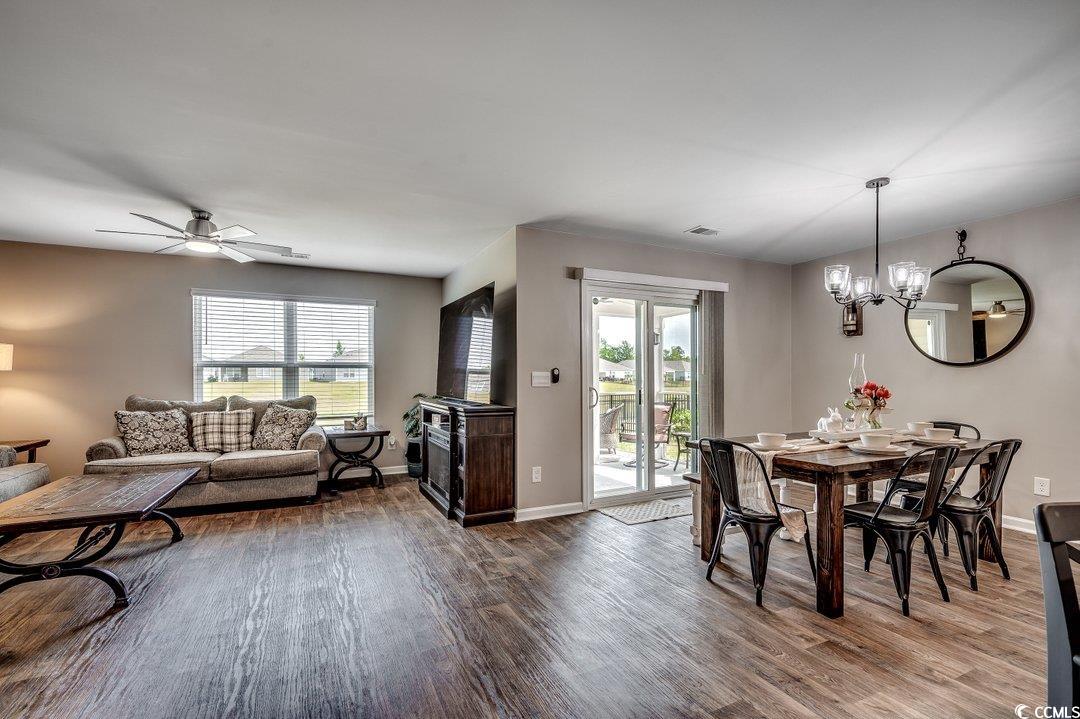 777 Woodland Farms Circle Aynor, SC 29511 - Photo 8 of 31 Dining area featuring baseboards, ceiling fan with notable chandelier, dark wood-style flooring, and plenty of natural light