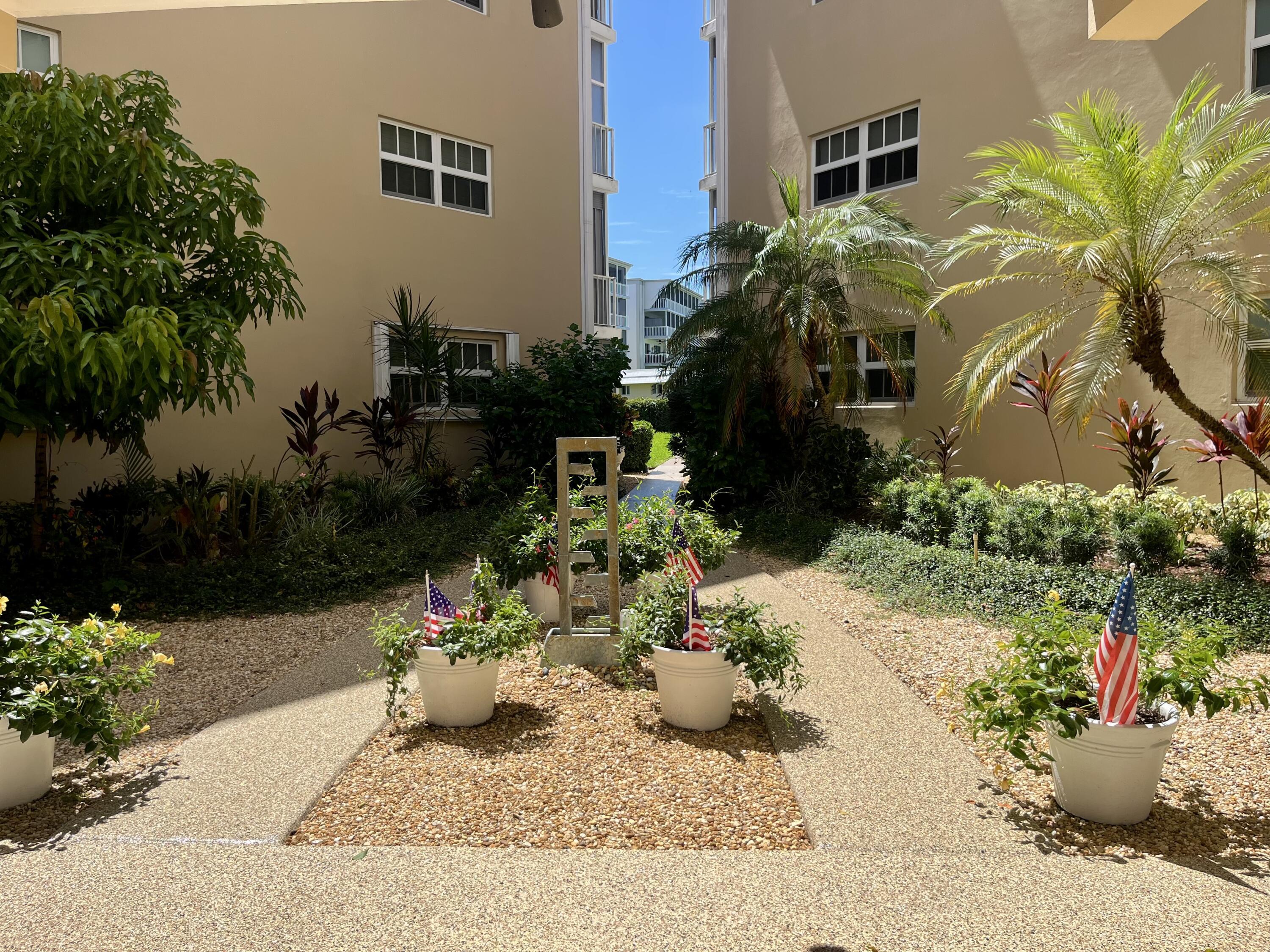 145 Atlantis Boulevard, Unit PH4 Atlantis, FL 33462 - Photo 23 of 27 a view of a backyard with plants and entertaining space