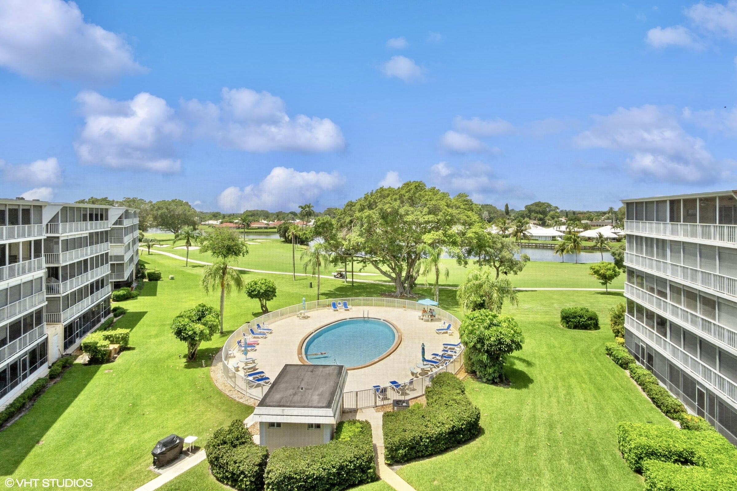 145 Atlantis Boulevard, Unit PH4 Atlantis, FL 33462 - Photo 27 of 27 a view of a swimming pool with a yard