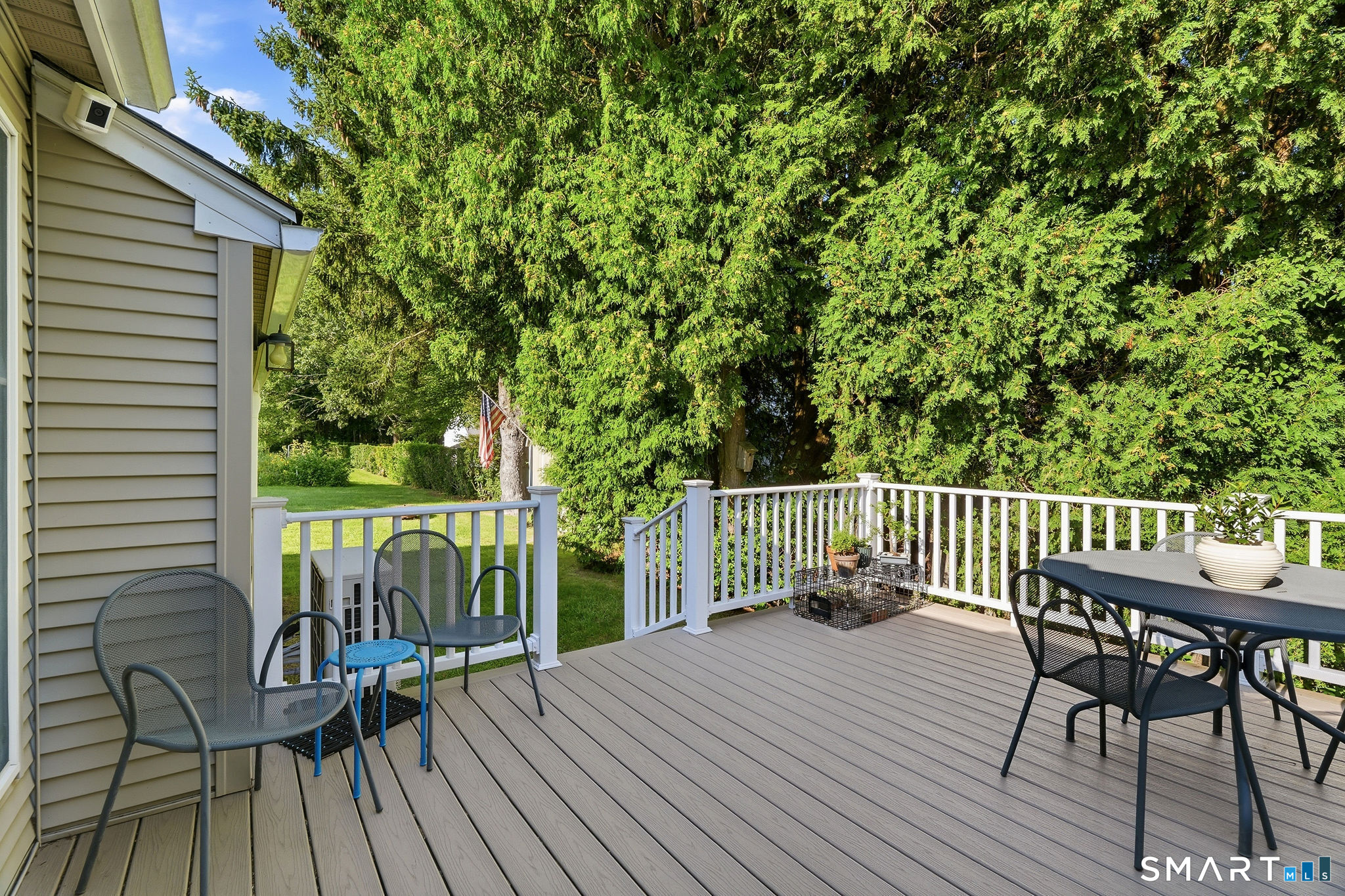 311 Brightwater Road Old Lyme, CT 06371 - Photo 31 of 39 Private deck - land extends beyond the hedge row to an open piece of land perfect for ball games!